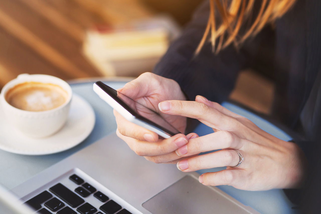 Close up of hands using mobile application on smartphone